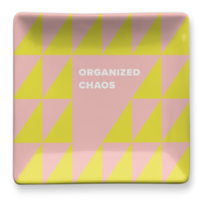 Yellow trinket tray for keeping small items neatly arranged.