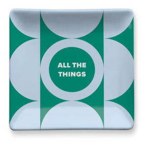 Green trinket tray for organizing keys and other essentials.