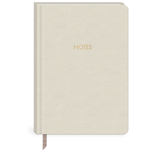 Cream hardcover journal for jotting down thoughts, travel stories, and dreams.